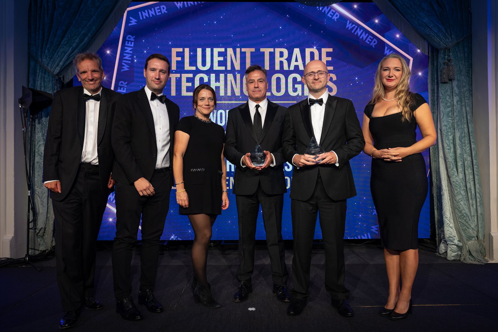 Fluent Trade Technologies team accepting two Euromoney Awards for Excellence in FX 2026 on stage